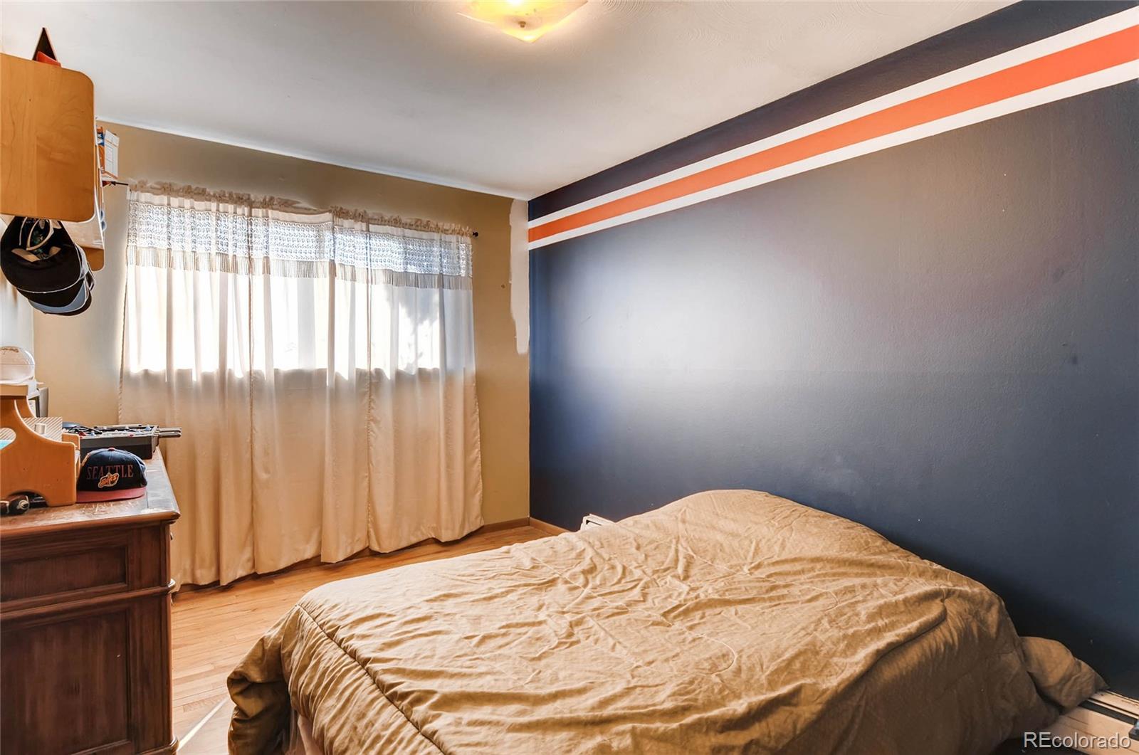 12475 West 38th Avenue Wheat Ridge, CO 80033 - Photo 15 of 22 a bedroom with a bed and a window
