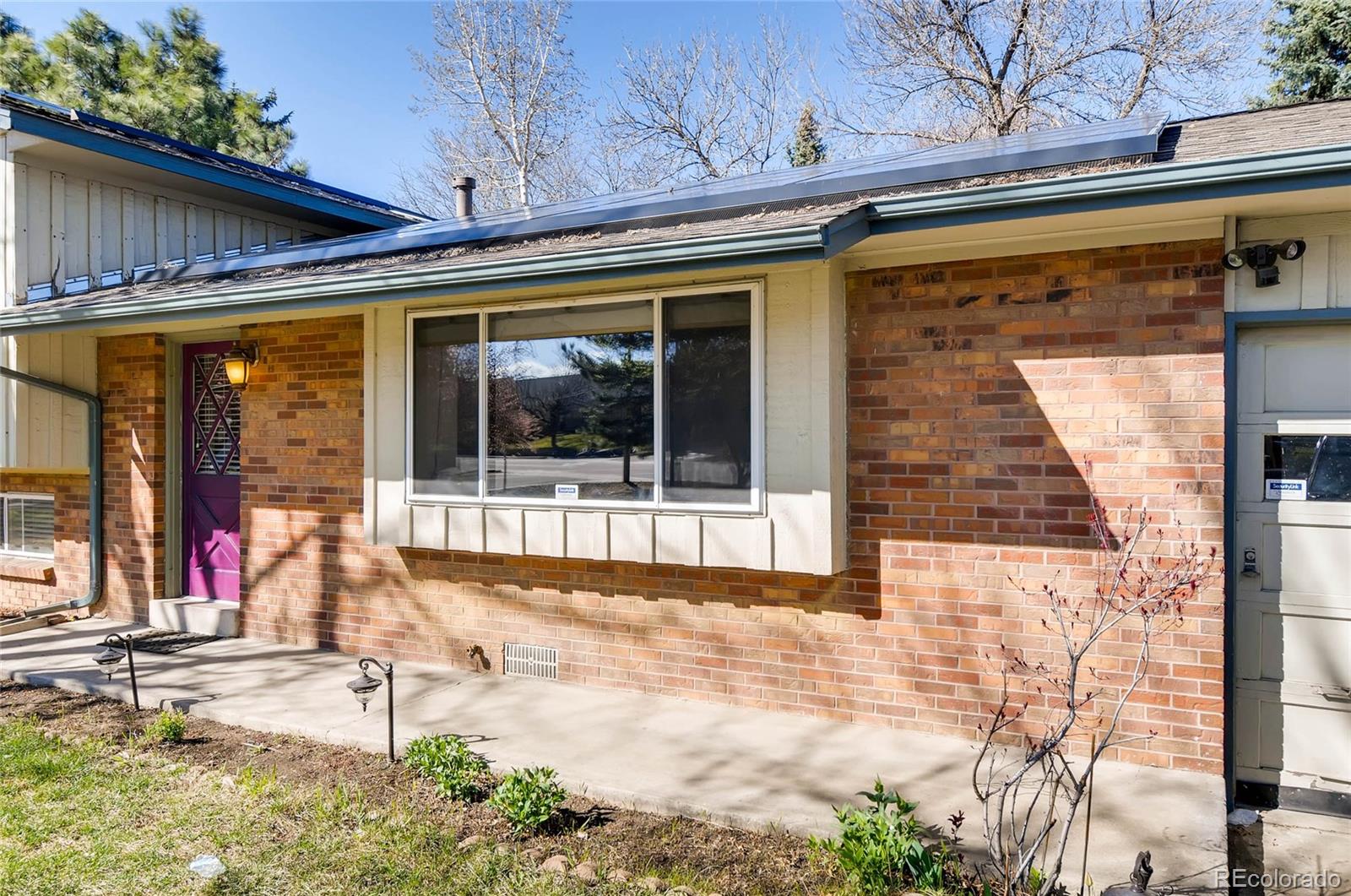 12475 West 38th Avenue Wheat Ridge, CO 80033 - Photo 20 of 22 a view of a brick house with large windows