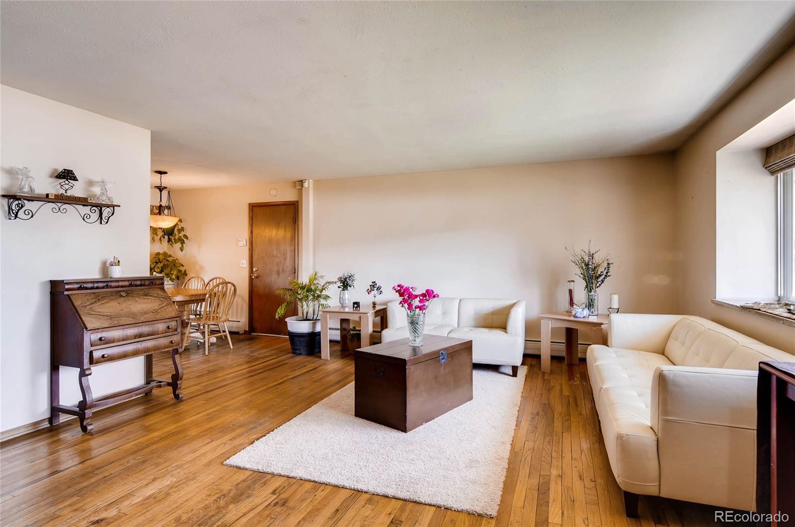 12475 West 38th Avenue Wheat Ridge, CO 80033 - Photo 2 of 22 a living room with furniture and wooden floor