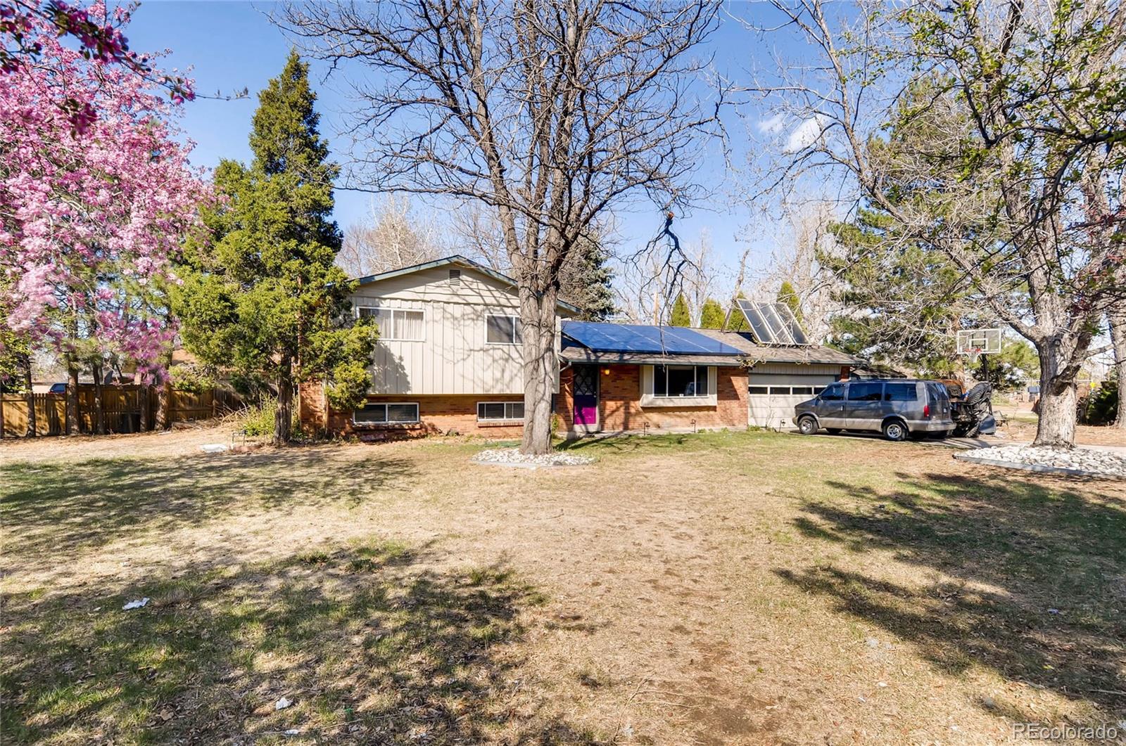 12475 West 38th Avenue Wheat Ridge, CO 80033 - Photo 21 of 22 a front view of a building with a yard