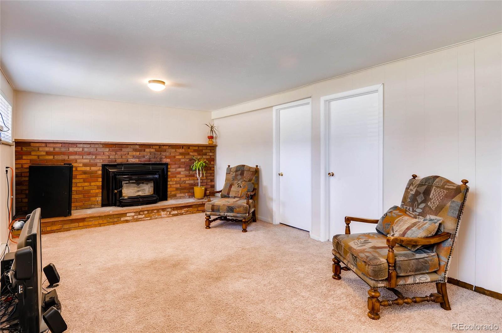 12475 West 38th Avenue Wheat Ridge, CO 80033 - Photo 4 of 22 a living room with furniture and a fireplace