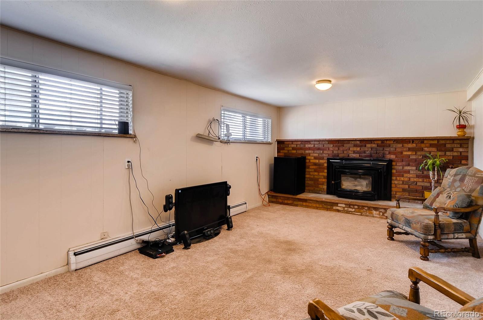 12475 West 38th Avenue Wheat Ridge, CO 80033 - Photo 5 of 22 a view of a livingroom with furniture and a fireplace