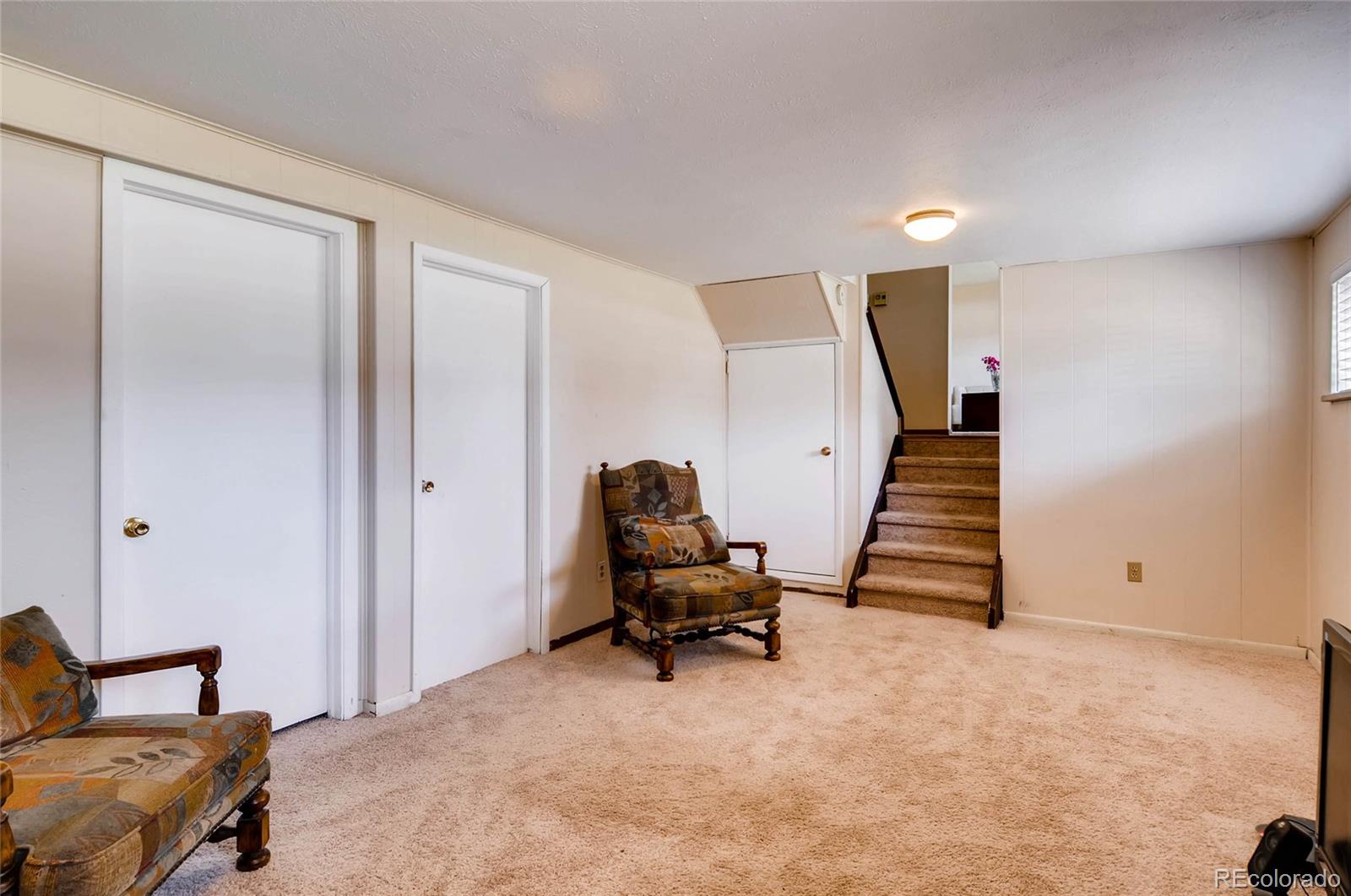 12475 West 38th Avenue Wheat Ridge, CO 80033 - Photo 6 of 22 a room with furniture and stairs