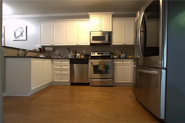 a kitchen with stainless steel appliances granite countertop a washer and dryer