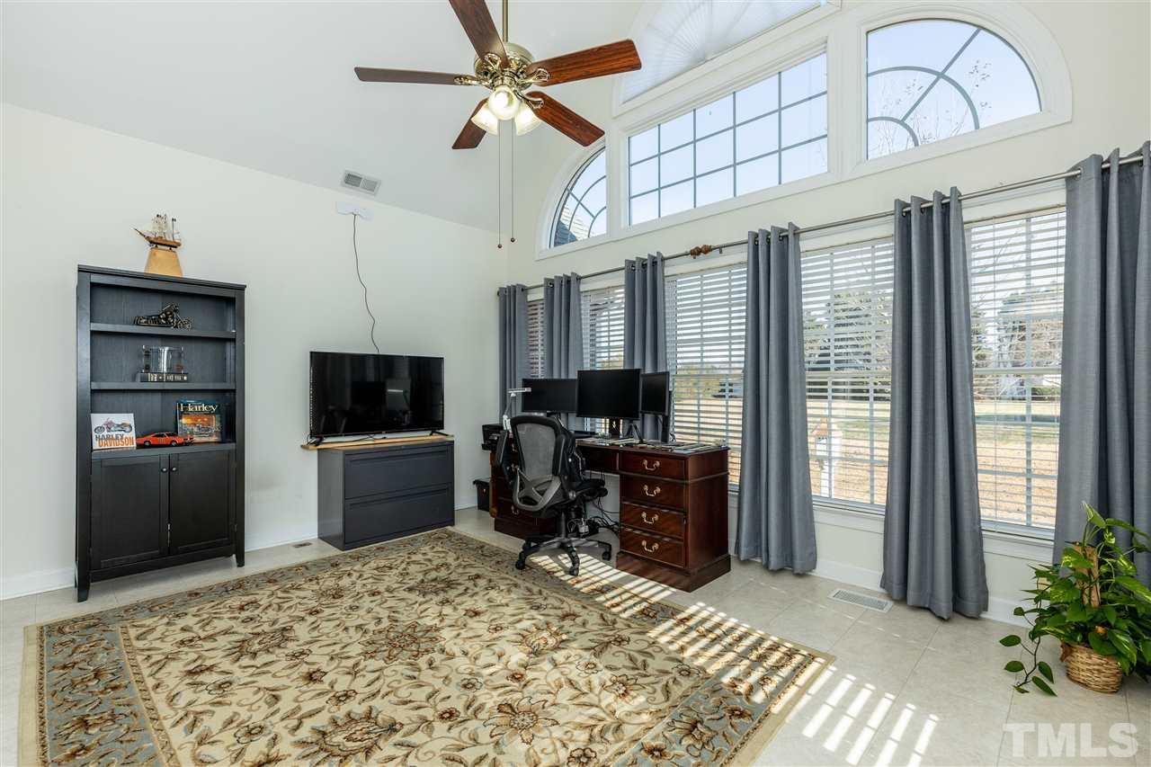 1016 Red Brick Road Garner, NC 27529 - Photo 11 of 29 a view of a livingroom with furniture and a flat screen tv