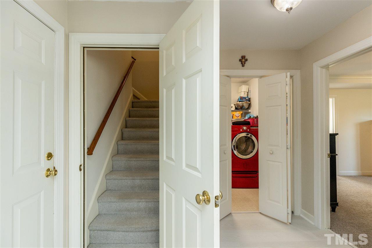 1016 Red Brick Road Garner, NC 27529 - Photo 19 of 29 a view of a hallway with washer and dryer
