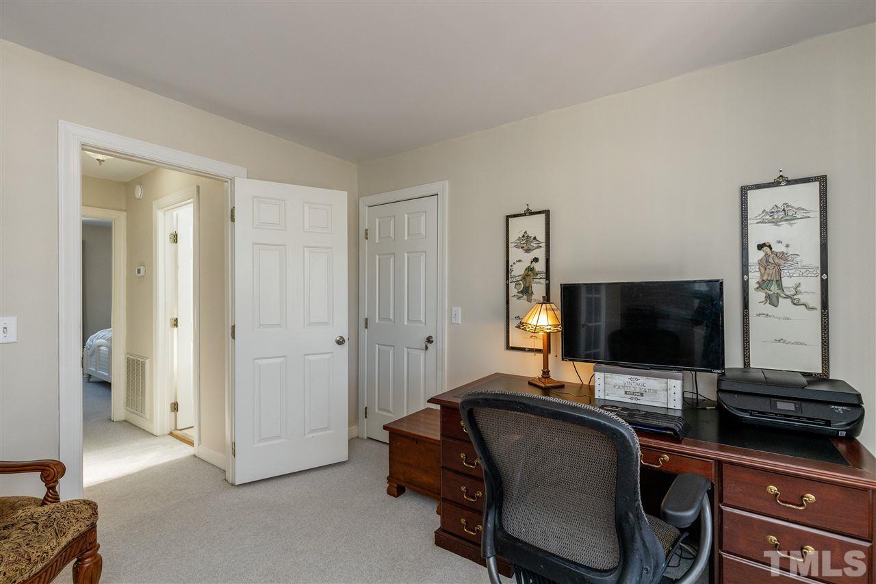 1016 Red Brick Road Garner, NC 27529 - Photo 4 of 29 a view of a livingroom with workspace and a flat screen tv