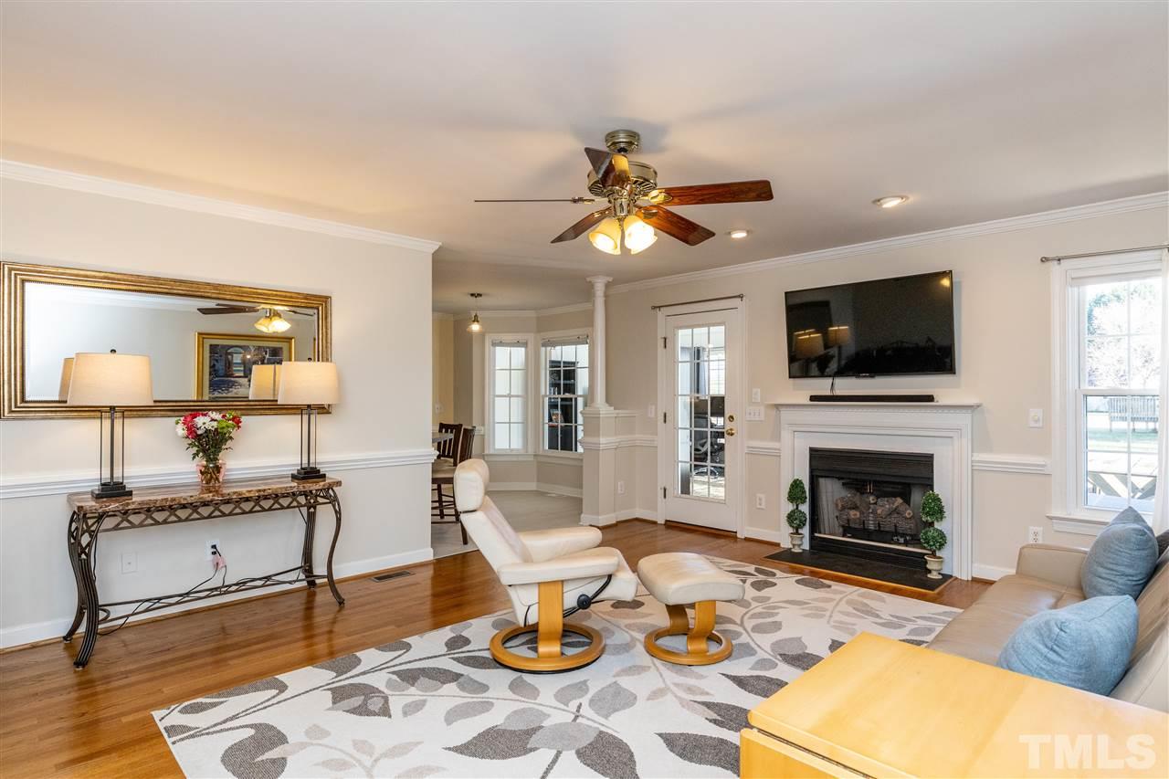 1016 Red Brick Road Garner, NC 27529 - Photo 6 of 29 a living room with furniture a fireplace and a flat screen tv