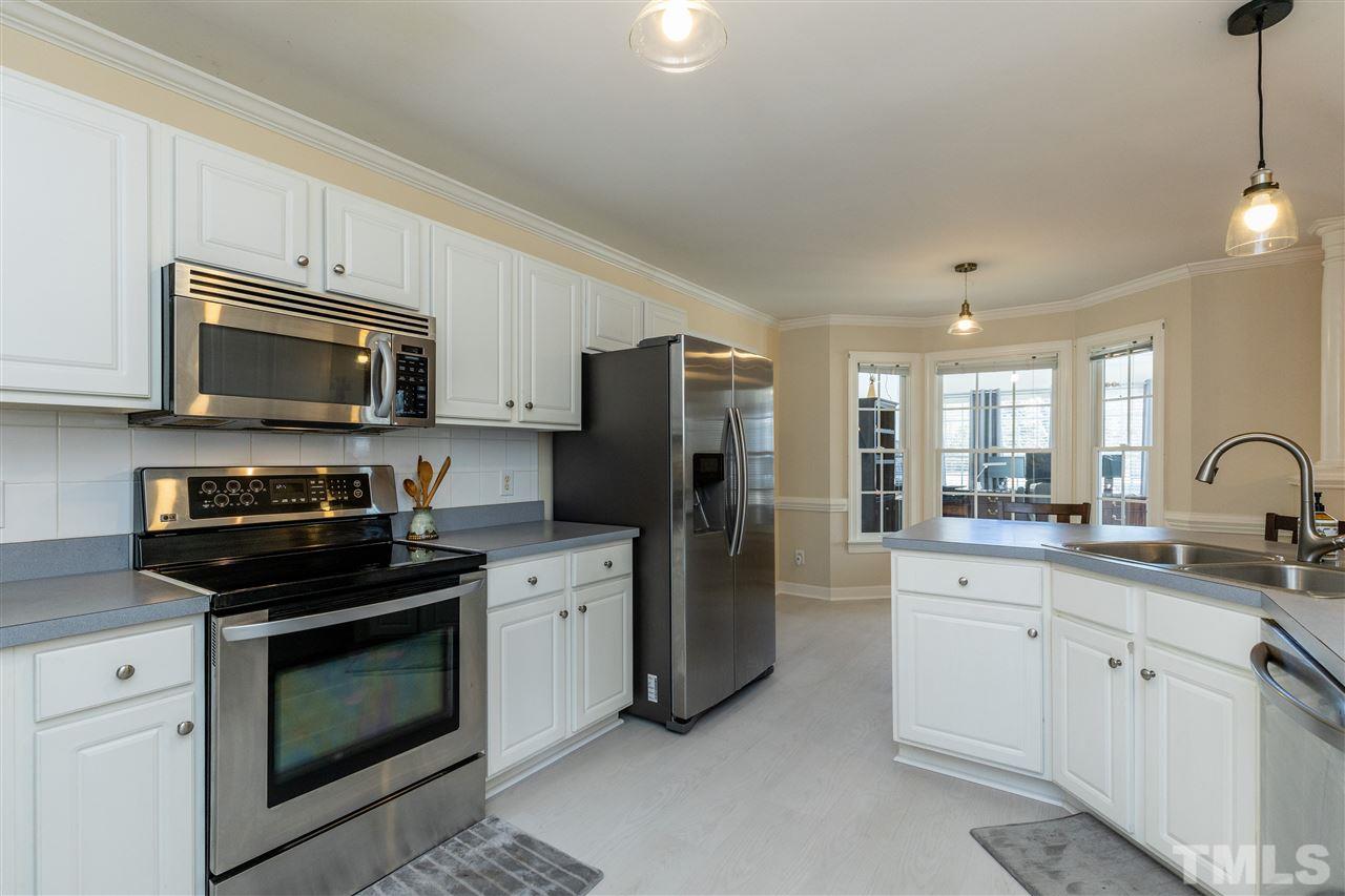 1016 Red Brick Road Garner, NC 27529 - Photo 8 of 29 a kitchen with a sink stove and refrigerator