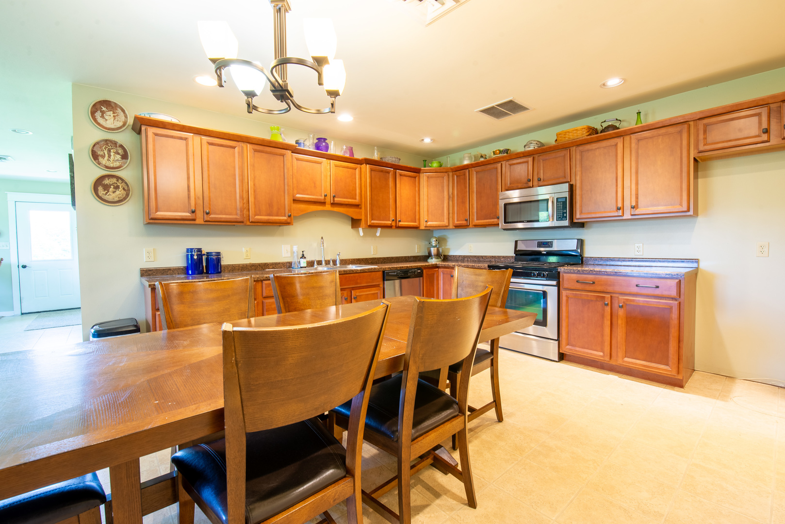 9109 Messmer Road Savanna, IL 61074 - Photo 21 of 31 a kitchen with kitchen island a stove a sink and a refrigerator