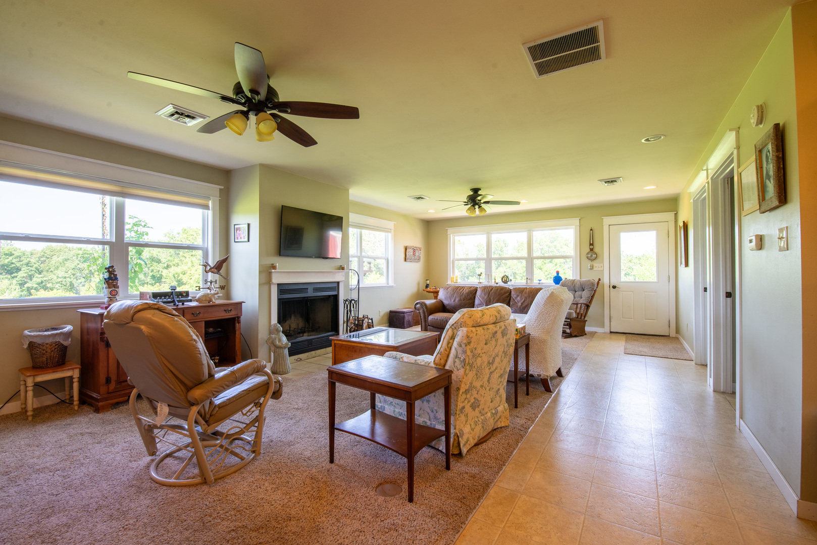 9109 Messmer Road Savanna, IL 61074 - Photo 24 of 31 a living room with furniture a fireplace and a large window