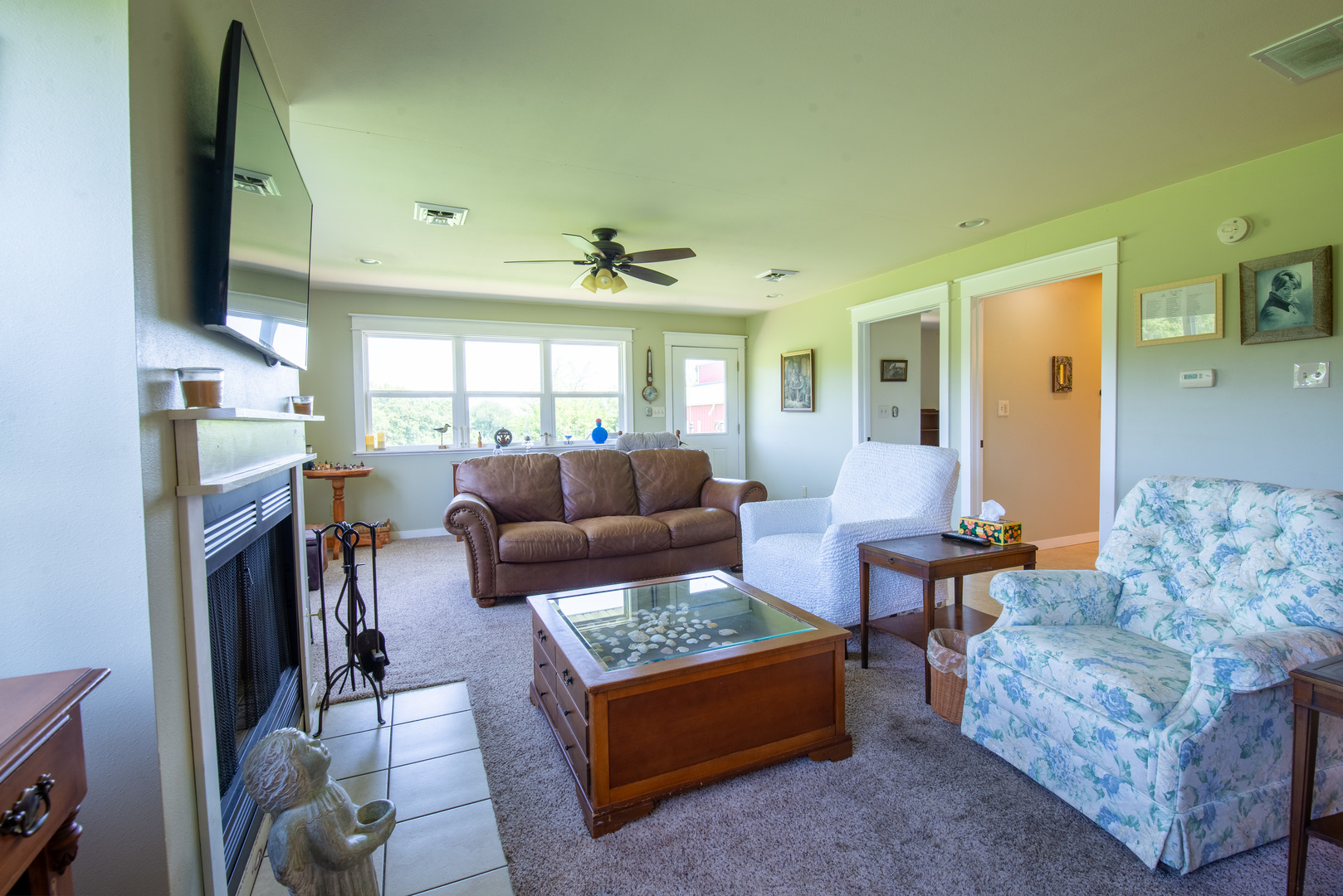 9109 Messmer Road Savanna, IL 61074 - Photo 28 of 31 a living room with furniture a large window and a flat screen tv