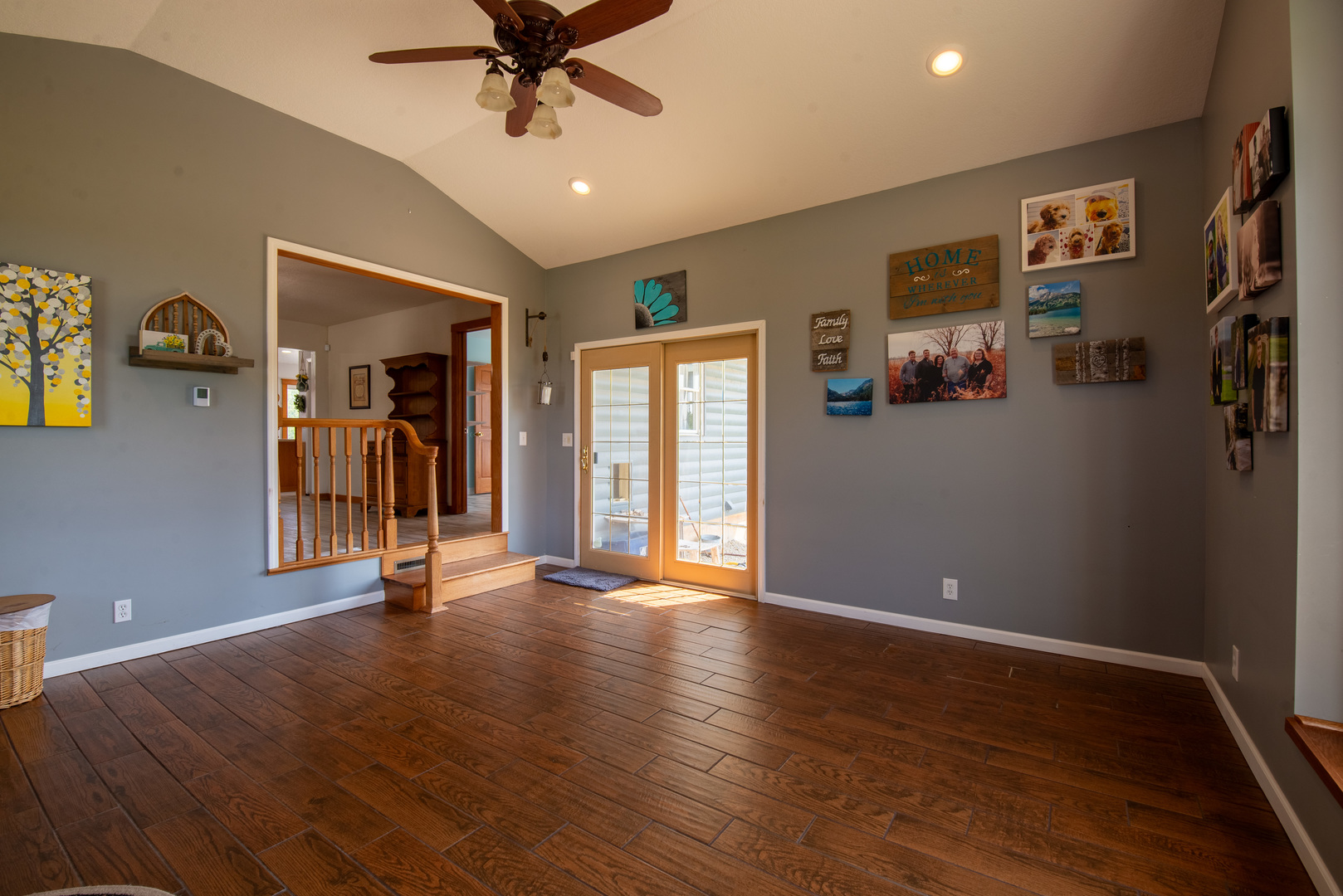 9109 Messmer Road Savanna, IL 61074 - Photo 3 of 31 a view of a livingroom with a hardwood floor and a ceiling fan