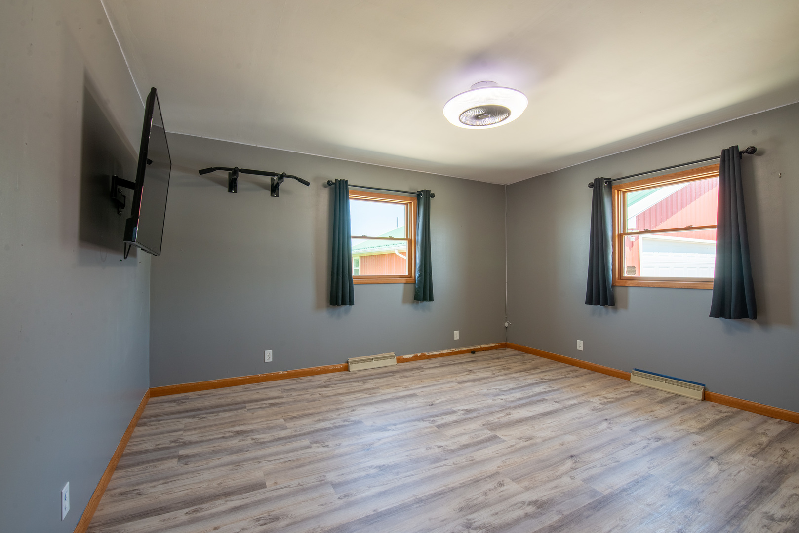 9109 Messmer Road Savanna, IL 61074 - Photo 9 of 31 a view of an empty room with wooden floor and a window