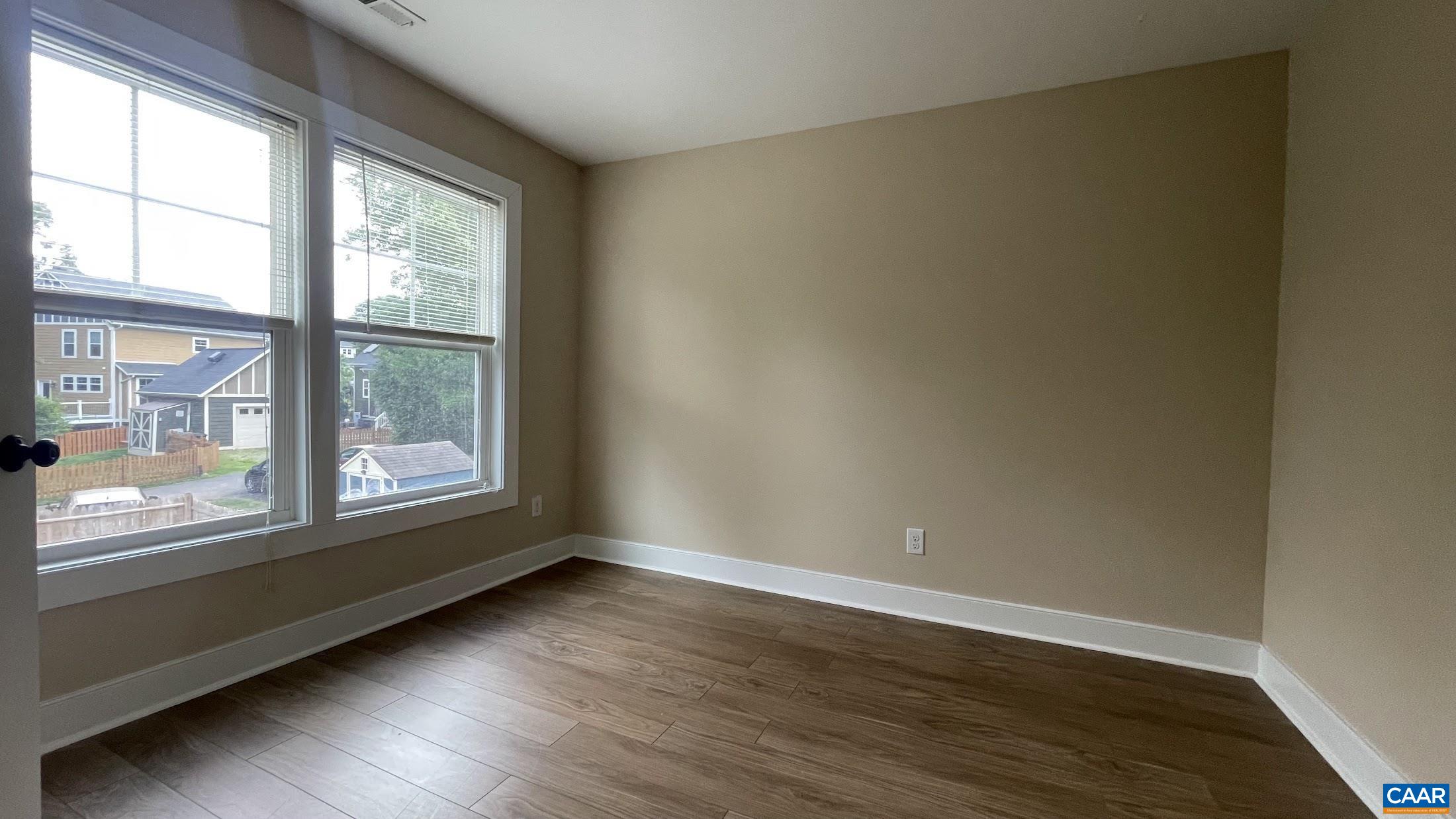 200 Harris Road Charlottesville, VA 22903 - Photo 24 of 28 an empty room with wooden floor and windows