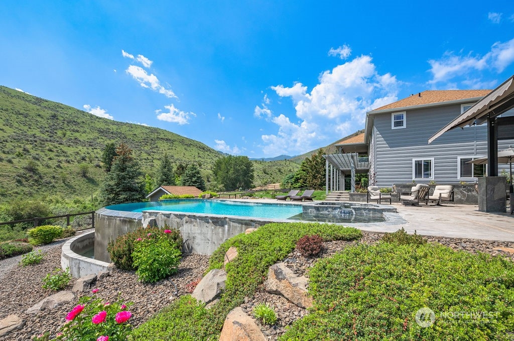 1665 Pitcher Canyon Road Wenatchee, WA 98801 - Photo 1 of 39 a view of a house with pool and chairs