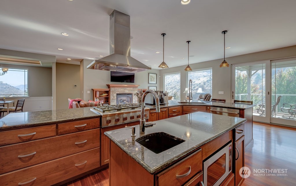 1665 Pitcher Canyon Road Wenatchee, WA 98801 - Photo 11 of 39 a kitchen with stainless steel appliances granite countertop a sink a stove and a wooden floor