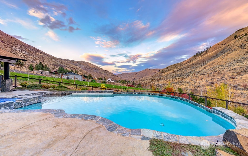 1665 Pitcher Canyon Road Wenatchee, WA 98801 - Photo 15 of 39 a view of a swimming pool and an ocean view