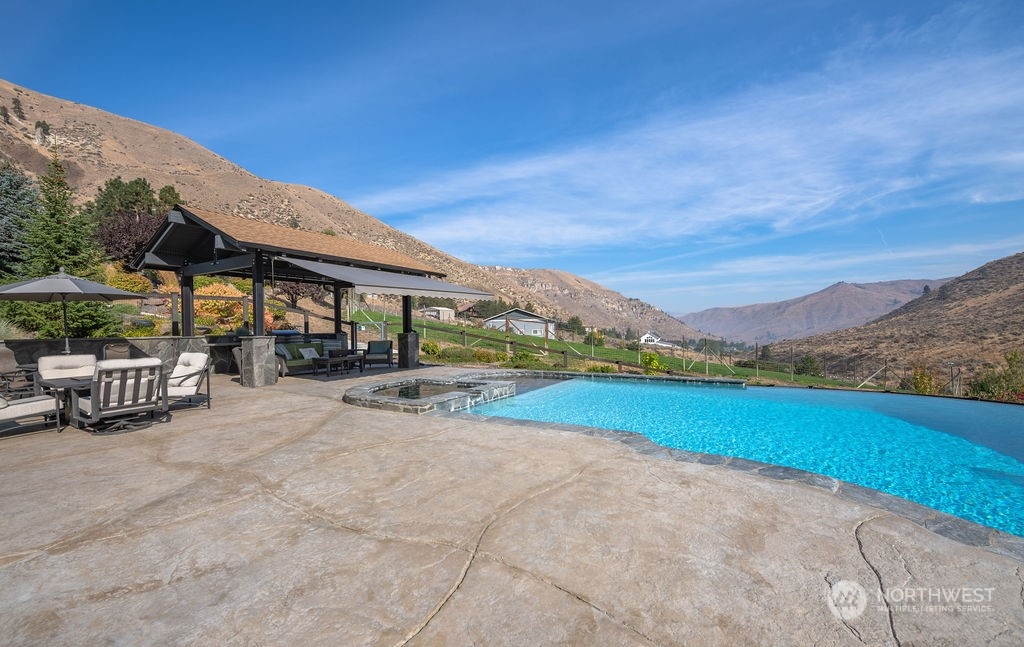 1665 Pitcher Canyon Road Wenatchee, WA 98801 - Photo 16 of 39 a view of a house with pool and a yard