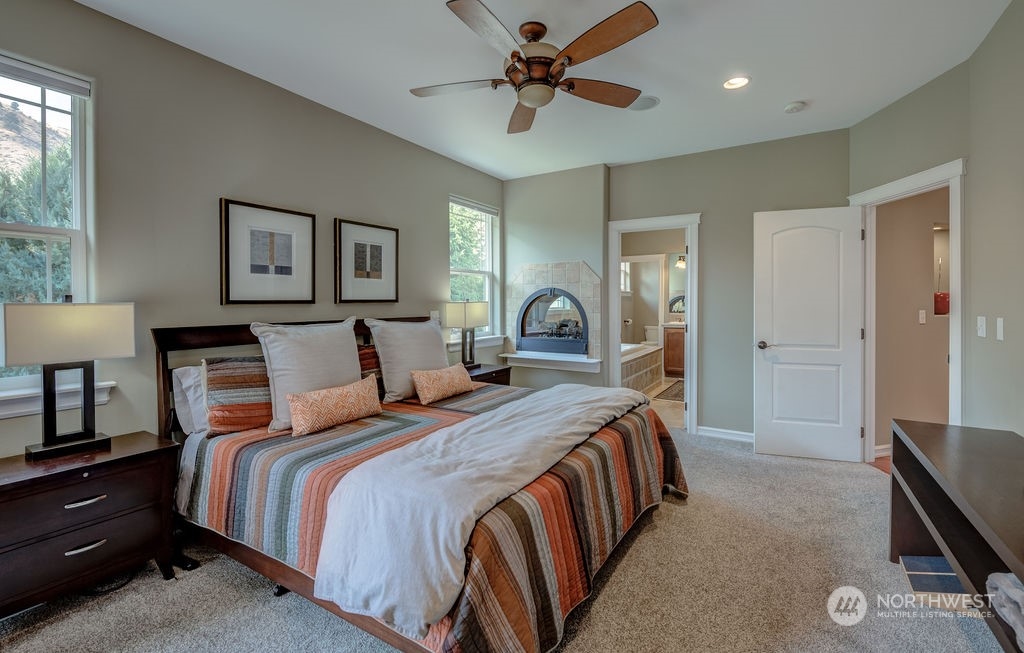 1665 Pitcher Canyon Road Wenatchee, WA 98801 - Photo 18 of 39 a bedroom with bed and a chandelier