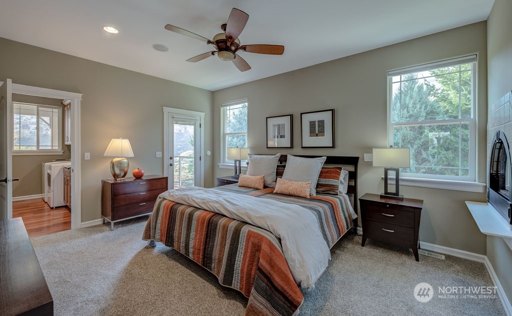 1665 Pitcher Canyon Road Wenatchee, WA 98801 - Photo 19 of 39 a bedroom with a bed and a chandelier