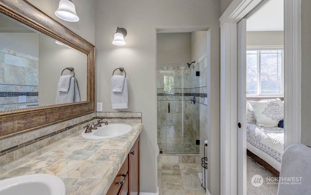 1665 Pitcher Canyon Road Wenatchee, WA 98801 - Photo 22 of 39 a bathroom with a granite countertop sink mirror and shower