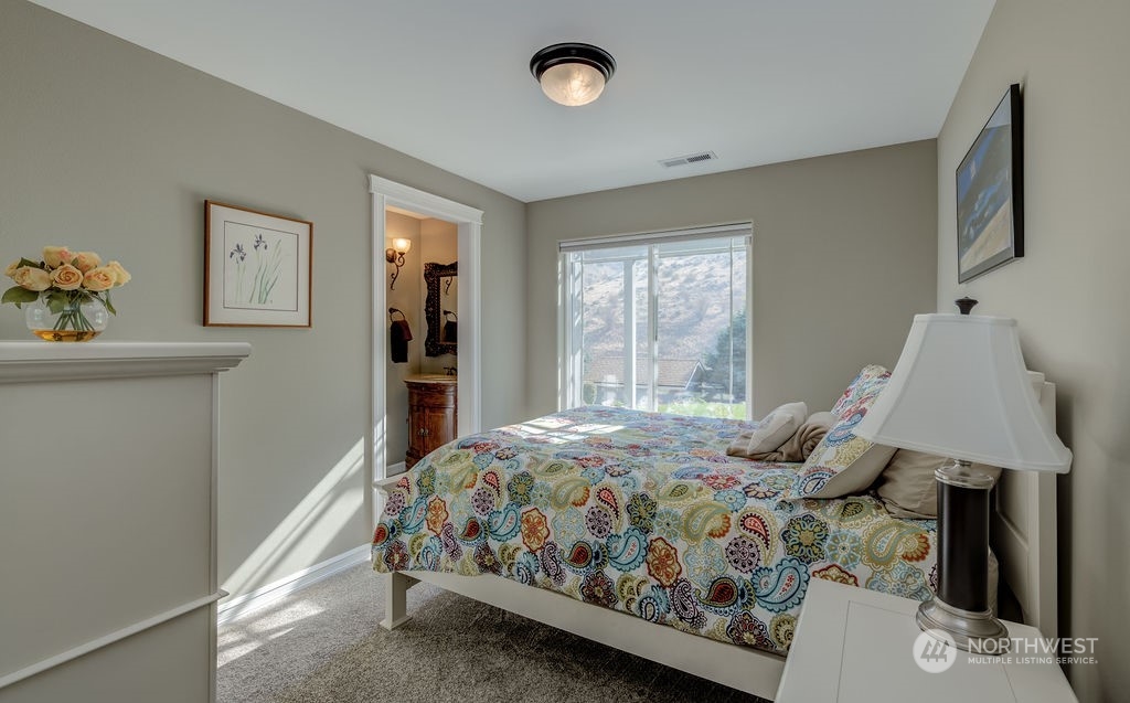 1665 Pitcher Canyon Road Wenatchee, WA 98801 - Photo 28 of 39 a bedroom with a bed table closet and a window