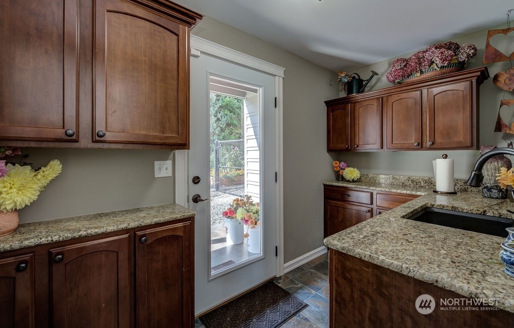 1665 Pitcher Canyon Road Wenatchee, WA 98801 - Photo 31 of 39 a kitchen with granite countertop a sink cabinets and stainless steel appliances