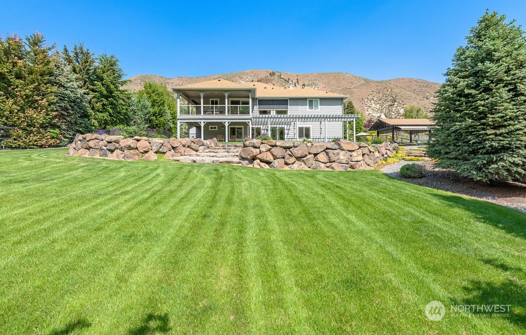 1665 Pitcher Canyon Road Wenatchee, WA 98801 - Photo 35 of 39 a view of a house with a backyard