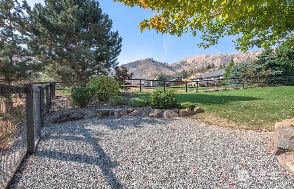 1665 Pitcher Canyon Road Wenatchee, WA 98801 - Photo 37 of 39 a view of a yard and a house in the background