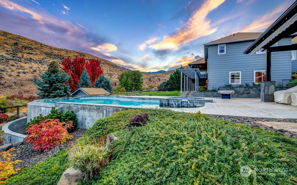 1665 Pitcher Canyon Road Wenatchee, WA 98801 - Photo 4 of 39 a front view of a house with a yard and potted plants