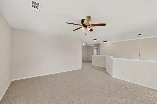 a view of a livingroom with a ceiling fan and window