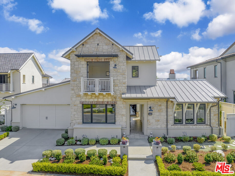 a front view of a house with a yard and outdoor seating