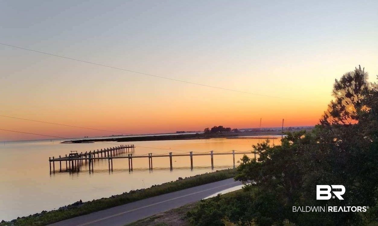 9100 Shell Belt Road Coden, AL 36523 - Photo 35 of 38 Coastal water frontage featuring an extensive pier, expansive water body, and distant land formations under a broad sky