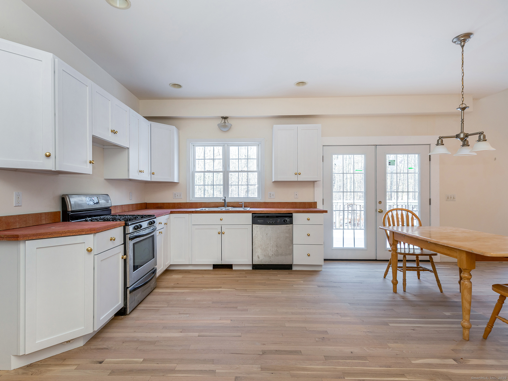 36 Sunset Lane Washington, CT 06794 - Photo 11 of 23 a kitchen with stainless steel appliances granite countertop a white cabinets and wooden floor