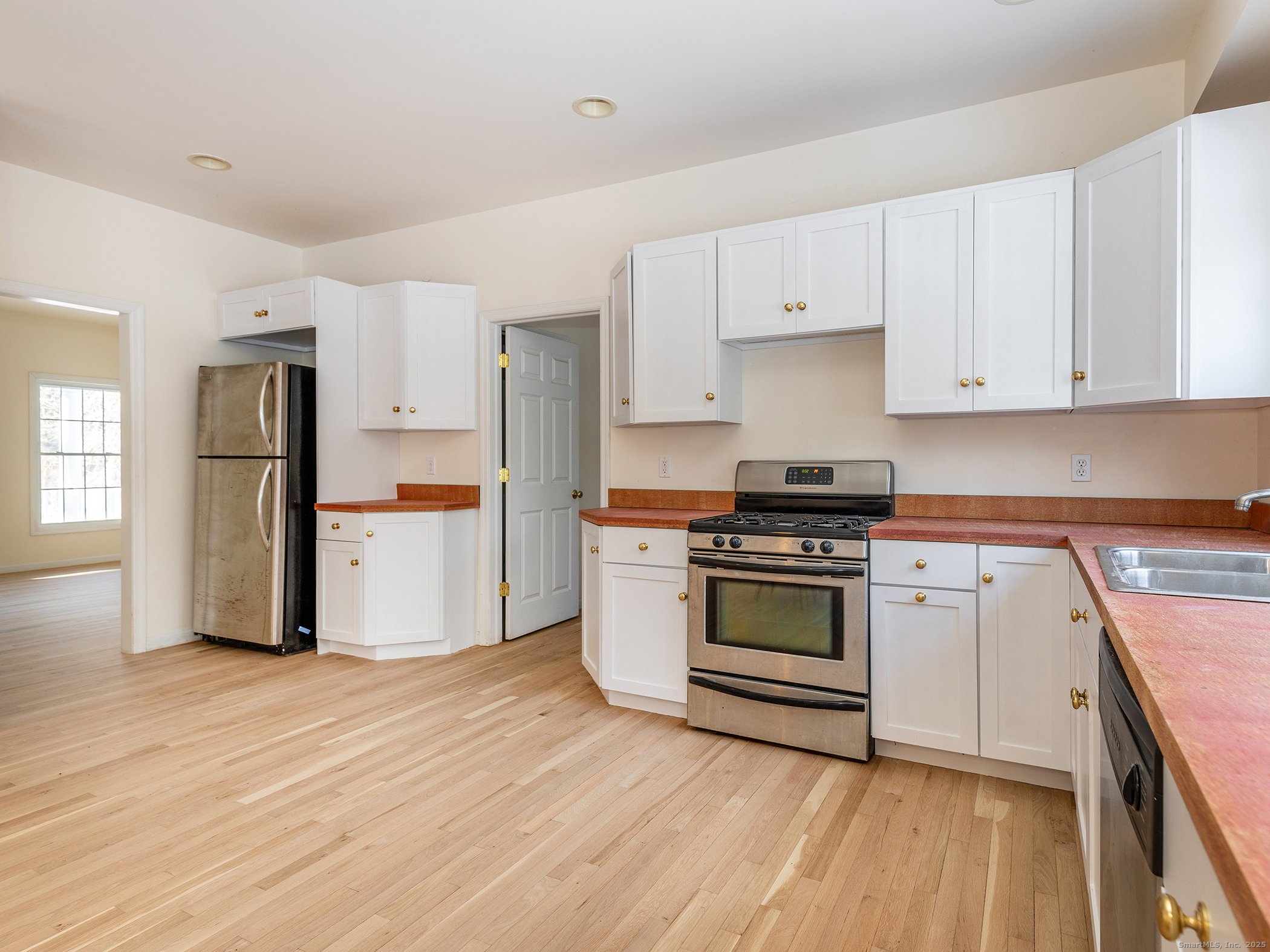 36 Sunset Lane Washington, CT 06794 - Photo 12 of 23 a kitchen with a white cabinets and wooden floor