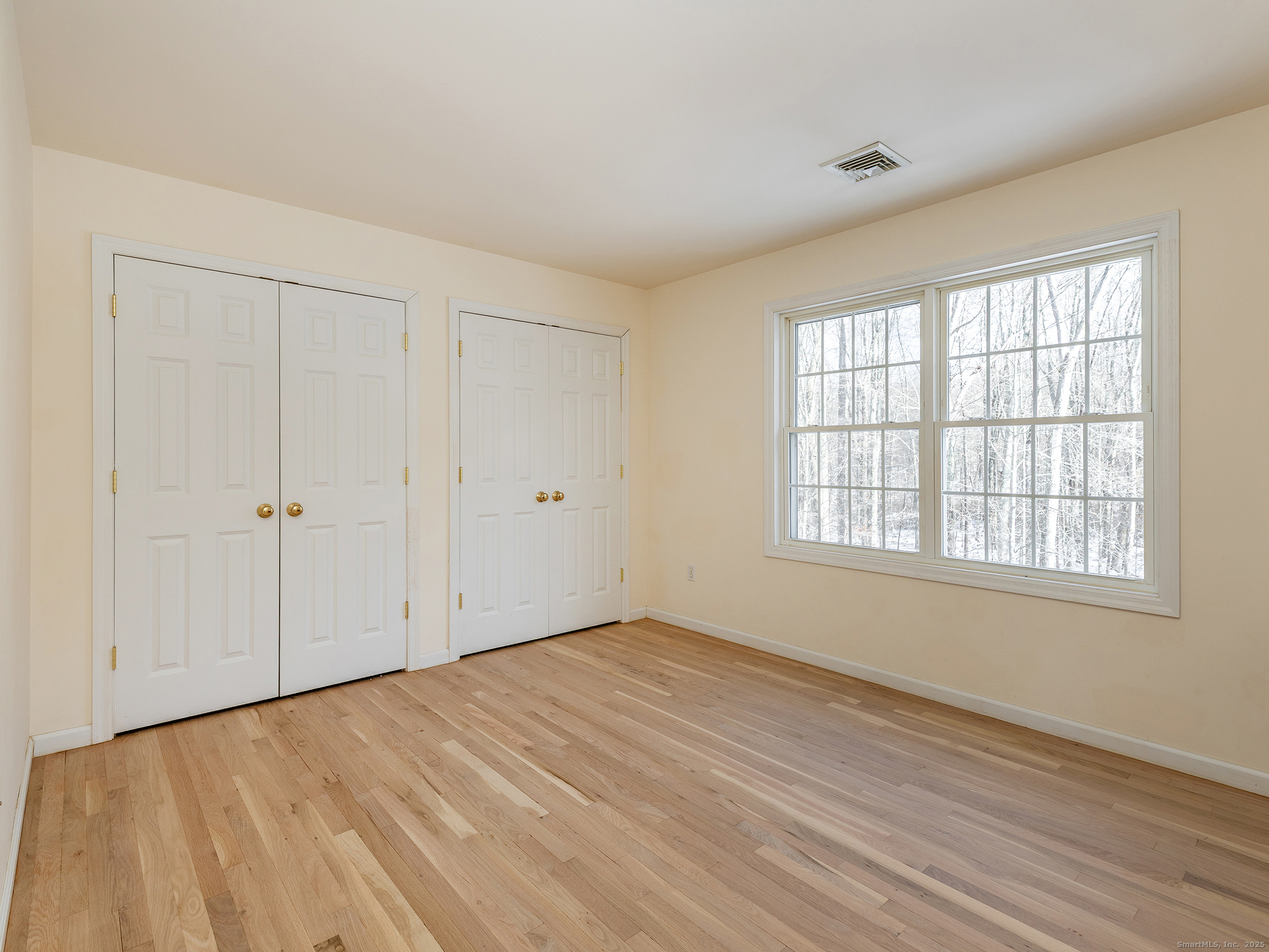 36 Sunset Lane Washington, CT 06794 - Photo 18 of 23 an empty room with wooden floor and windows