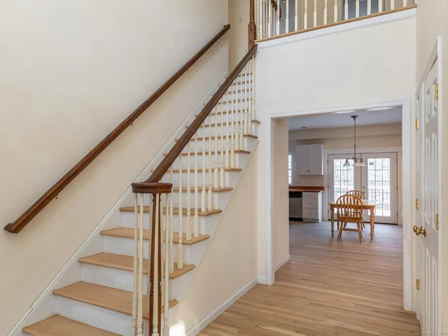 a view of entryway and hall with wooden floor