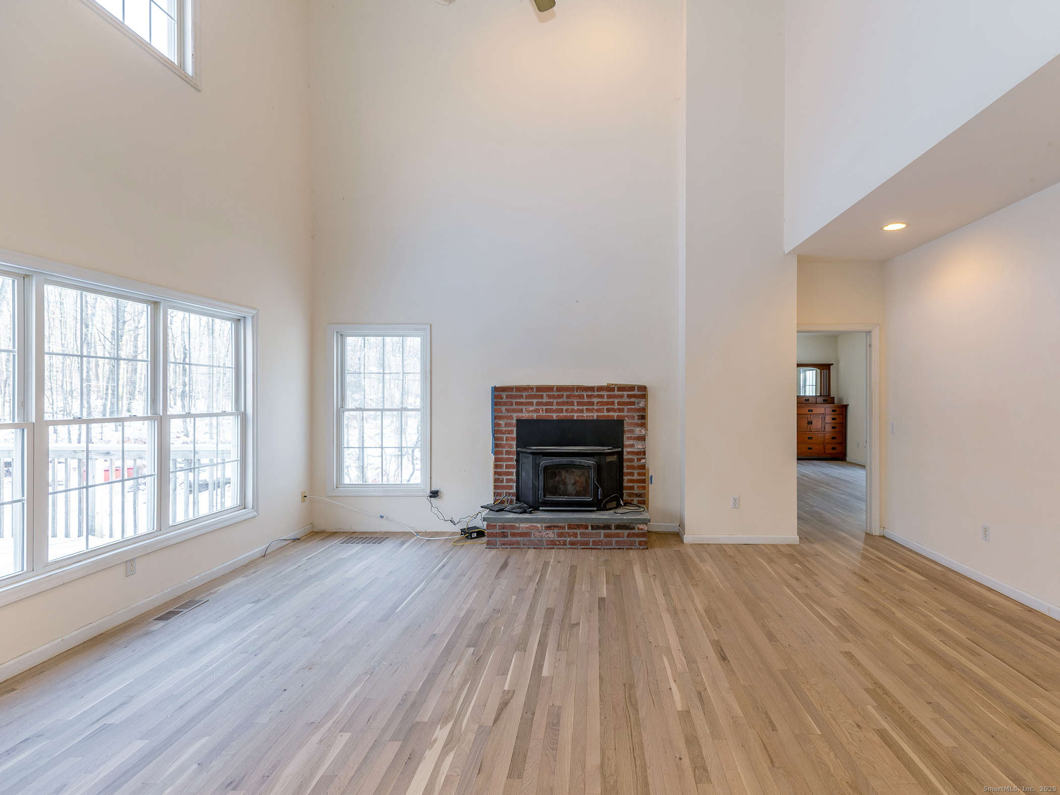 36 Sunset Lane Washington, CT 06794 - Photo 9 of 23 wooden floor in an empty room with a fireplace