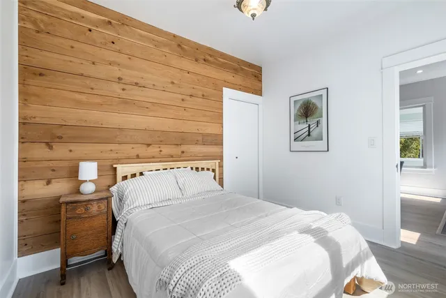 a bedroom with a bed and a night stand