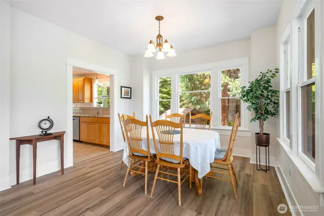 a view of a dining room with furniture window and wooden floor