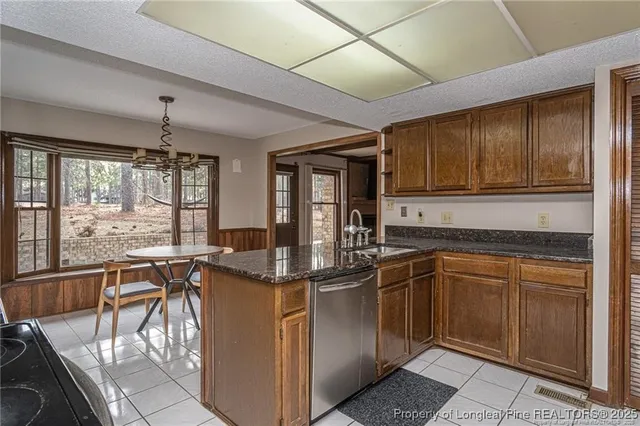a kitchen with stainless steel appliances granite countertop sink stove and cabinets