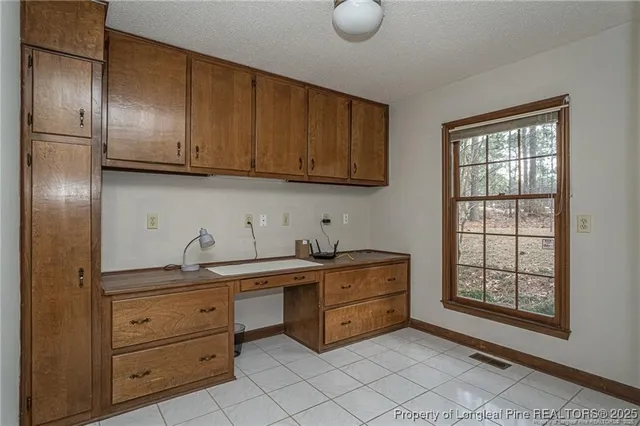 a kitchen with stainless steel appliances granite countertop a sink window and cabinets