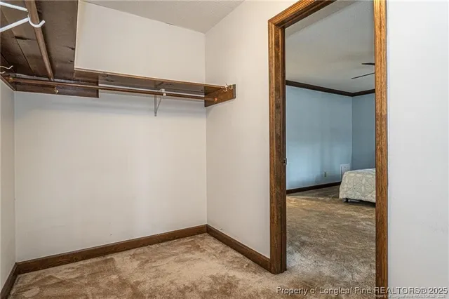 a bedroom with a bed and a ceiling fan