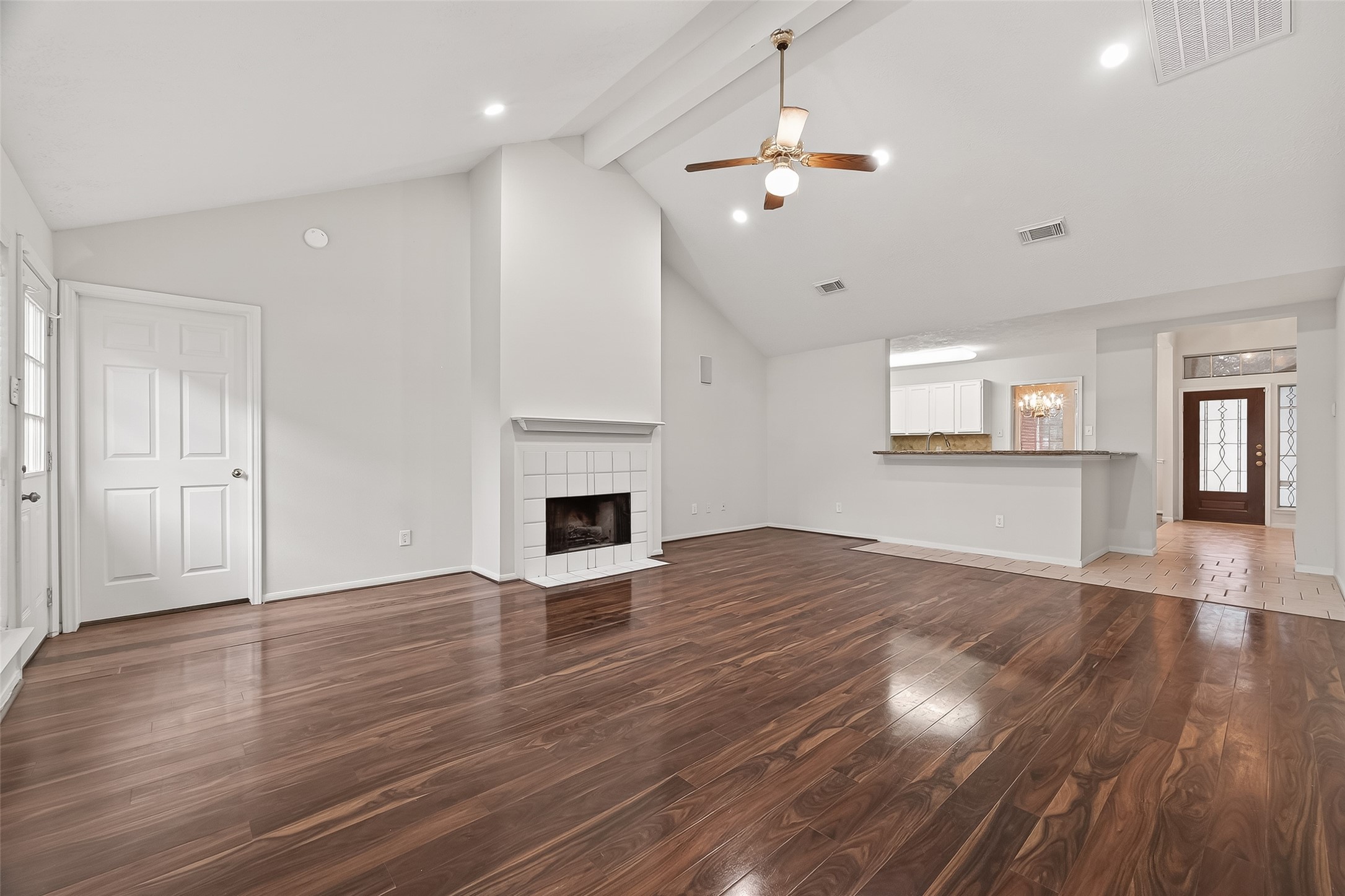 2002 Foundary Drive Katy, TX 77493 - Photo 6 of 20 an empty room with wooden floor fireplace and windows