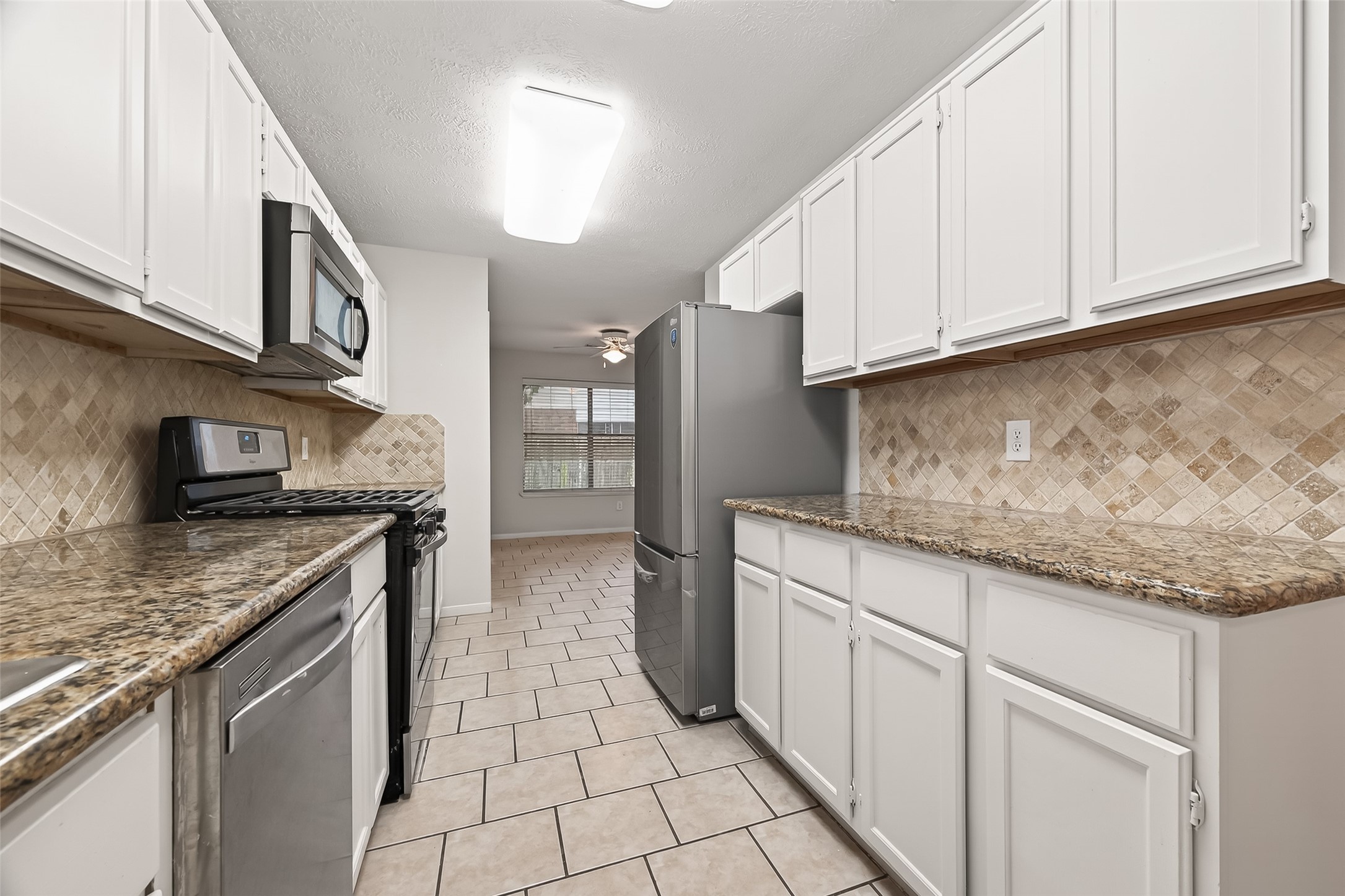 2002 Foundary Drive Katy, TX 77493 - Photo 7 of 20 a kitchen with stainless steel appliances granite countertop a sink and a stove
