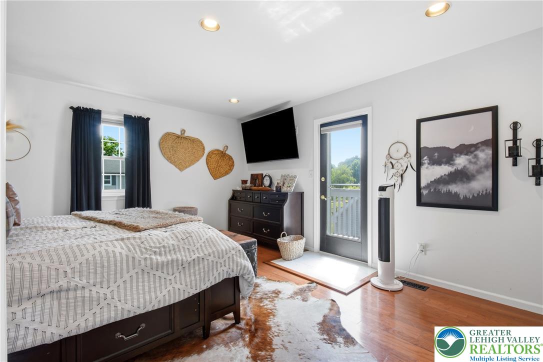 890 Lahr Road Nazareth, PA 18064 - Photo 29 of 71 Hardwood flooring extends throughout this well-lit bedroom, offering direct balcony access.