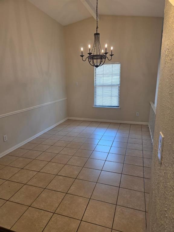 10371 White Elm Road Dallas, TX 75243 - Photo 5 of 11 Unfurnished room with light tile patterned floors and a chandelier