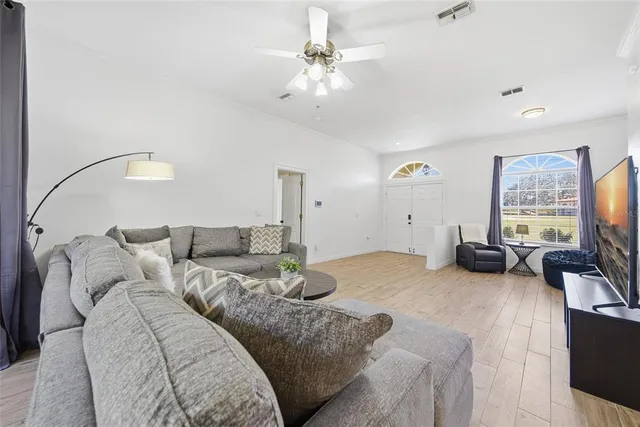 a living room with furniture a couch and a flat screen tv