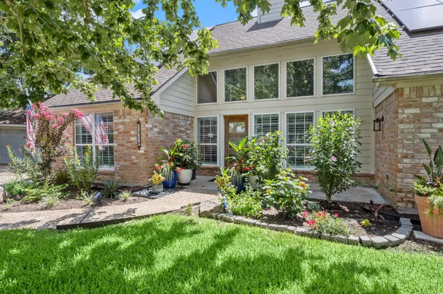 a view of a chair and table in backyard of the house